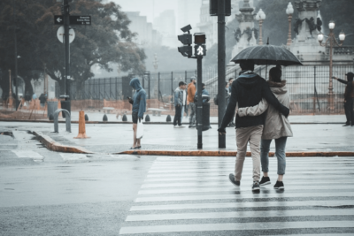 couple walking in the rain under an umbrella